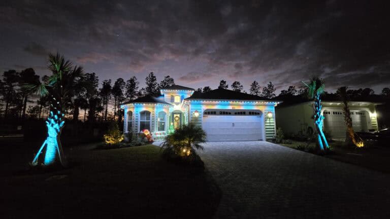 Latitude Margaritaville home displaying a festive color pattern with permanent Gemstone Lights installed by Atlantic Outdoor Lighting